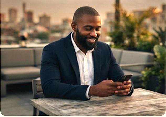 Man smiling at his phone while answering quick questions about his partner